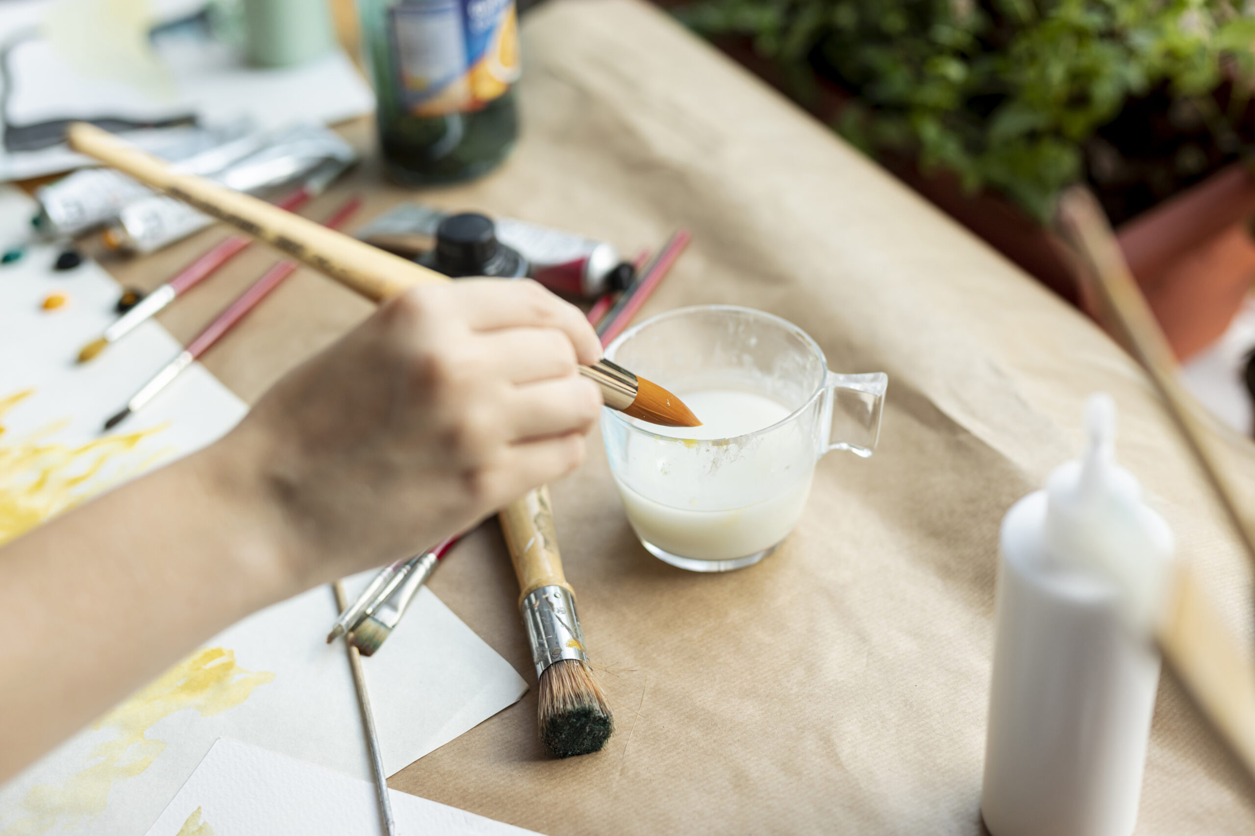 high-angle-hand-holding-painting-brush