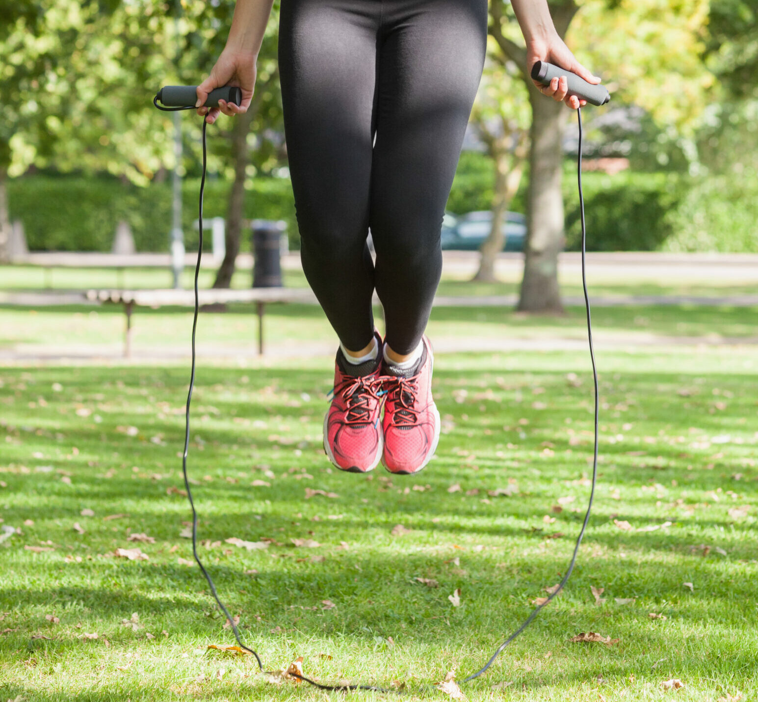 Strained blonde woman skipping in a park