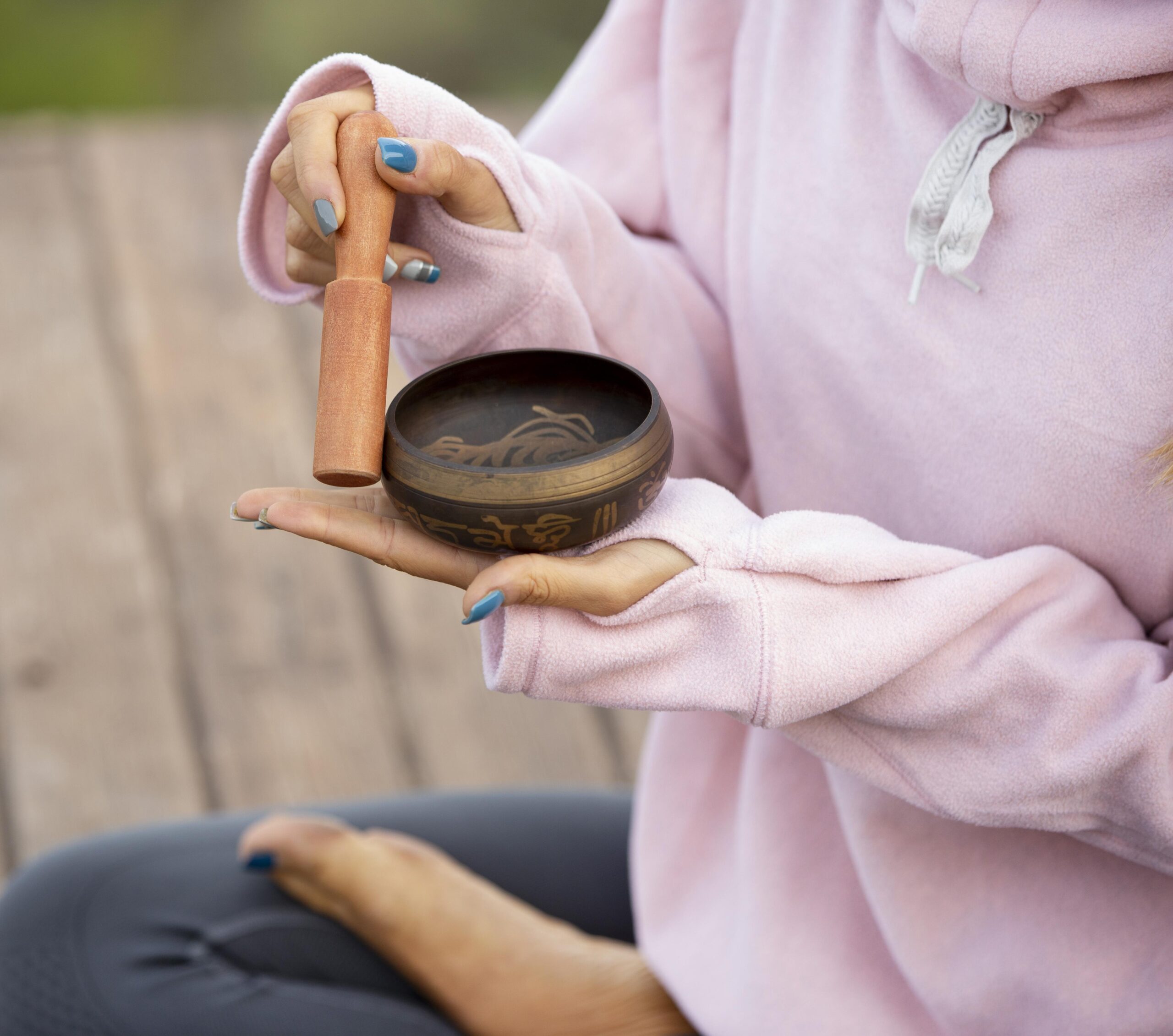 woman-outdoors-holding-singing-bowl